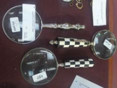 Two magnifying glasses one with checkered handle the other with baluster handle