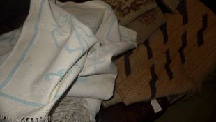 A collection of three hand knotted rugs