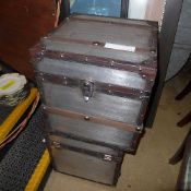 A pair of leather bound metallic trunks