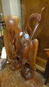 A pair of similar carved wooden birds