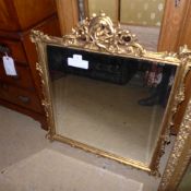 A gilted wall hanging mirror with cherub decoration