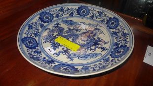 A Delft style charger with dragon decoration and character mark to base (a/f)