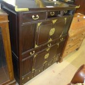 A C20th Korean hardwood side cabinet with an arrangement of drawers and cupboards
