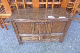 An oak linen fold panel coffer with base drawers