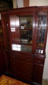 A mahogany bookcase with glazed panels and cupboards on plinth base