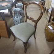 A set of four Victorian mahogany balloon back dining chairs with wrapover seats on cabriole