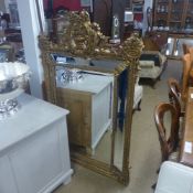 A gilted sectional wall hanging mirror