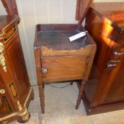 A late Georgian mahogany pot cupboard the tray top above cupboard on turned supports (a/f)