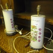 A pair of Chinese porcelain cylindrical table lamps with bird and flower decoration on carved