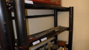 An ebonised three tiered bamboo bookcase with open shelves