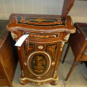 A French pier cabinet the serpentine top above inlaid drawer and cupboard