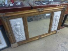 A gilted wall hanging mirror with marble plaques