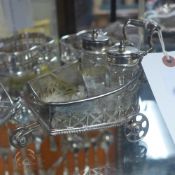 A silver plated cruet in the form of a cart