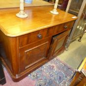 A Victorian mahogany low side cabinet with drawers above cupboards on plinth base