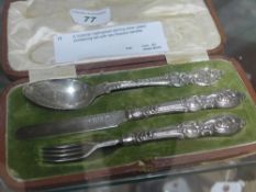 A Victorian hallmarked sterling silver cased christening set with neo Rococo handles