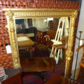 A Victorian carved giltwood wall mirror/overmantel the rectangular plate flanked by lion mask relief