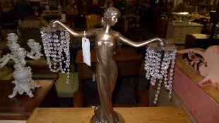 An Art Deco lamp lady with outstretched arms with lustres