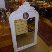 A French design white painted overmantel mirror the carved crest above bevelled plate