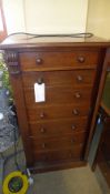 A Victorian mahogany Wellington chest having fitted secretaire drawer raised on plinth base