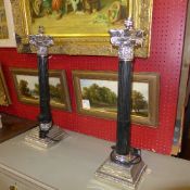 A pair of Corinthian style silvered table lamps