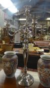 A chromium five light chandelier on stepped base