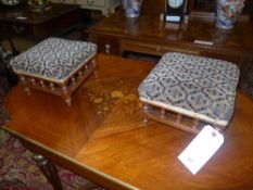A pair of small stools upholstered in geometric pattern on oak spindles
