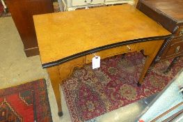 A Biedermeier design burr elm veneered desk with single drawer on splayed supports