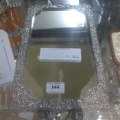 A silver embossed dressing mirror