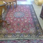 An extremely fine central Persian part silk Qum rug the central floral medallion on a rouge field