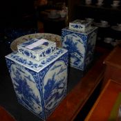 A pair of Chinese style blue and white vases with lids