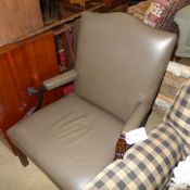 A Gainsborough chair upholstered in brown leather on stretchered supports