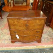 A C20th walnut side cabinet with panel doors above drawers