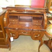 A French design walnut cylindrical desk the fitted interior above drawers on cabriole supports