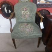 A Hepplewhite design walnut open armchair the oval pad back above wrap-over seat upholstered in