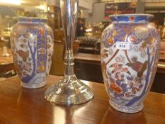 A pair of Imari palette porcelain vases with pictorial panels