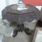 A profusely carved Burmese table the octagonal top raised on carved animal triform base W 78 H 76