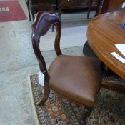 A set of four Victorian mahogany dining chairs with faux leather seats on reeded supports