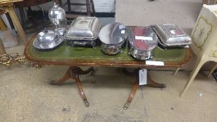 A C20th mahogany low table with leather inset on twin pedestal bases