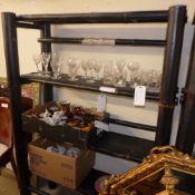 An ebonised three tiered bamboo bookcase with open shelves
