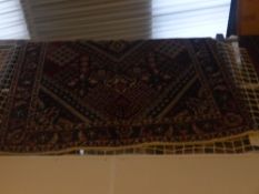 A fine North West Persian Bakhtar rug central pendant medallion on a terracotta field within