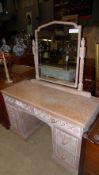 A C20th limed oak dressing chest having mirror upstand above carved drawers and cupboard
