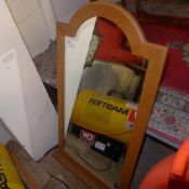 An oak wall mirror with arched plate