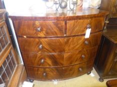 A Victorian mahogany bow front chest with two short above three long drawers on turned feet