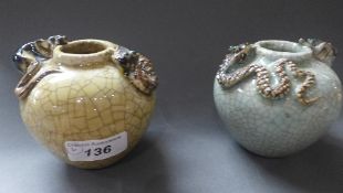 A pair of Chinese pottery vases, crackle glaze with dragons in relief
