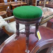 A Victorian mahogany piano stool with pad seat on turned support