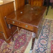 A Victorian mahogany pembroke table with end drawer on tapering turned supports