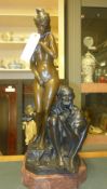 A bronzed figure of a nude female and Arab seller