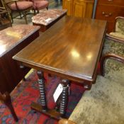 A Victorian mahogany stretcher table the rectangular top on bobbin turned support