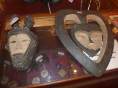 A central African love mask together with another similar