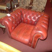 A Chesterfield armchair upholstered in buttoned red leather